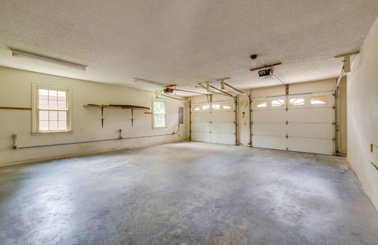 garage, two car garage, garage doors, concrete flooring, windows