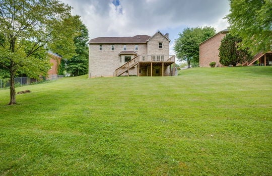 back yard, back of home, back deck, brick exterior, trees