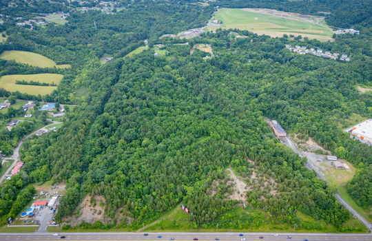 aerial photo, undeveloped land, 48+/- acres, commercial land for sale, trees, neighboring businesses, stone drive, mountain views, 1100'+ Road Frontage, prime Kingsport Location