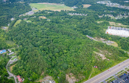 aerial photo, undeveloped land, 48+/- acres, commercial land for sale, trees, neighboring businesses, stone drive, mountain views, 1100'+ Road Frontage, prime Kingsport Location