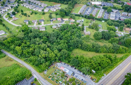 commercial property for sale, 5.62+/- acres, stone drive kingsport tn, neighboring homes, neighboring businesses, mountain views, aerial photo, road
