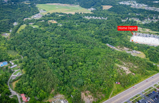 aerial photo, undeveloped land, 48+/- acres, commercial land for sale, trees, neighboring businesses, stone drive, mountain views, 1100'+ Road Frontage, prime Kingsport Location, marker showing proximity to Home Depot