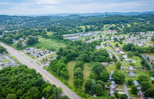 commercial property for sale, 5.62+/- acres, stone drive kingsport tn, neighboring homes, neighboring businesses, mountain views, aerial photo, road