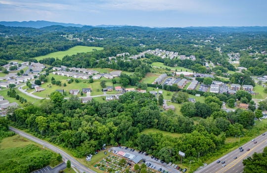 commercial property for sale, 5.62+/- acres, stone drive kingsport tn, neighboring homes, neighboring businesses, mountain views, aerial photo, road