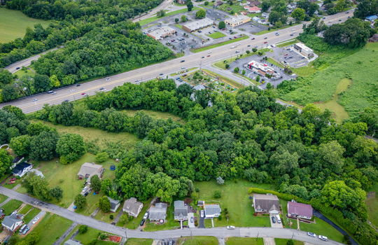commercial property for sale, 5.62+/- acres, stone drive kingsport tn, neighboring homes, neighboring businesses, mountain views, aerial photo, road