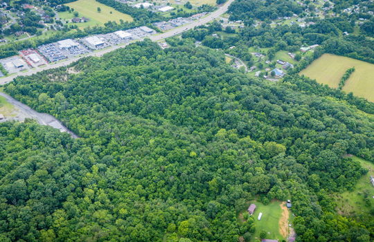 aerial photo, undeveloped land, 48+/- acres, commercial land for sale, trees, neighboring businesses, stone drive, mountain views, 1100'+ Road Frontage, prime Kingsport Location