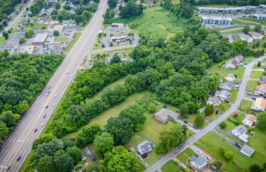 commercial property for sale, 5.62+/- acres, stone drive kingsport tn, neighboring homes, neighboring businesses, mountain views, aerial photo, road