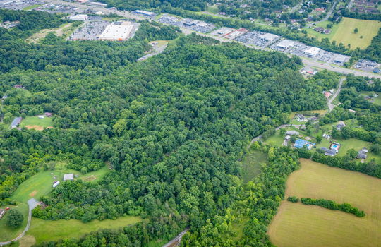 aerial photo, undeveloped land, 48+/- acres, commercial land for sale, trees, neighboring businesses, stone drive, mountain views, 1100'+ Road Frontage, prime Kingsport Location