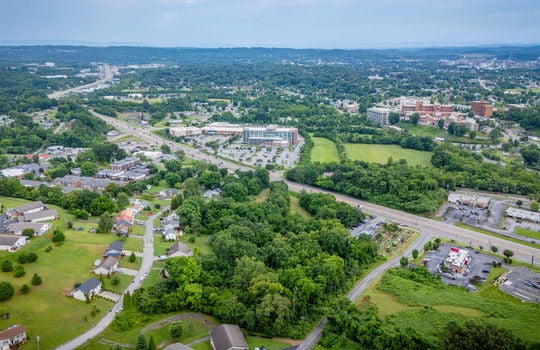 commercial property for sale, 5.62+/- acres, stone drive kingsport tn, neighboring homes, neighboring businesses, mountain views, aerial photo