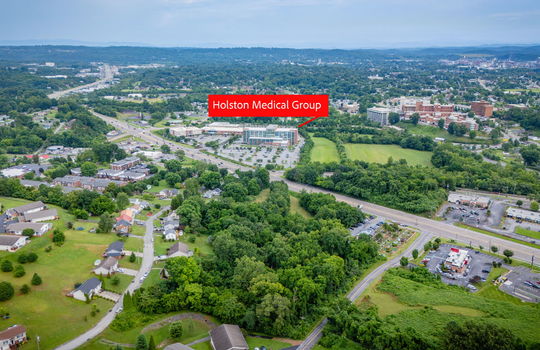 commercial property for sale, 5.62+/- acres, stone drive kingsport tn, marker showing proximity to Holston Medical Group, neighboring homes, neighboring businesses, mountain views, aerial photo