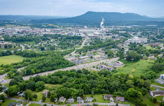 commercial land, 5.62+/- acres, stone drive kingsport, trees, neighboring homes, neighboring businesses, aerial photo, mountains