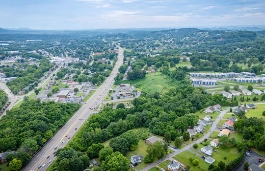 commercial land, 5.62+/- acres, stone drive kingsport, trees, neighboring homes, neighboring businesses, aerial photo, mountains