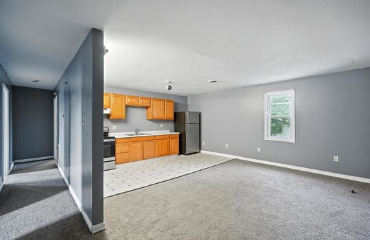 living room, kitchen, carpet, window, vinyl flooring, oven/range, cabinets, countertops, refrigerator