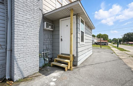 Downstairs studio apartment, front door, wooden stairs, brick exterior, for lease