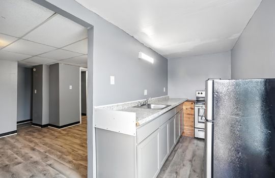 kitchen, refrigerator, stove, sink, luxury vinyl flooring, door to main living area