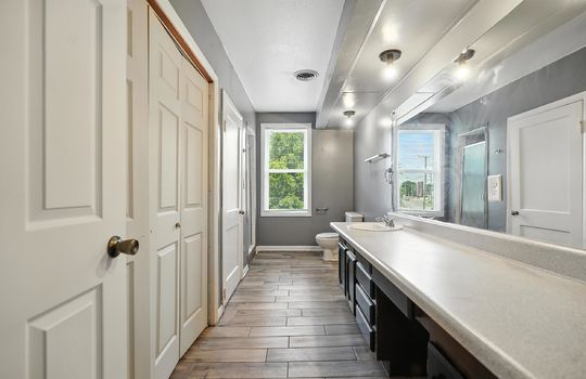 bathroom, luxury vinyl flooring, toilet, shower, closets