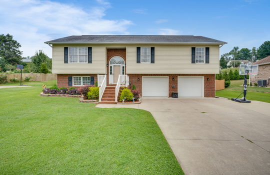 Split Foyer home, brick, vinyl siding, two car garage, concrete driveway, garage doors, landscaping, front yard