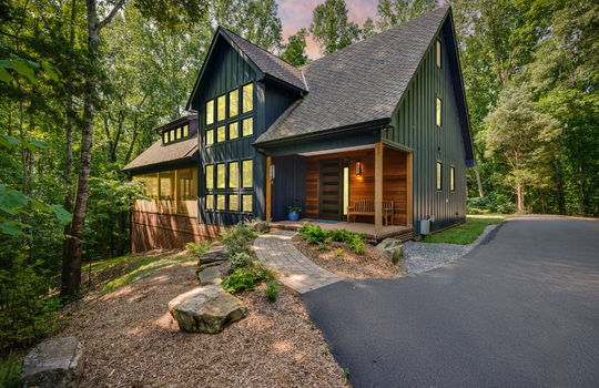Contemporary home, wood siding, metal siding, roof, driveway, trees