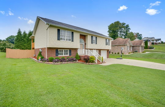 Split Foyer home, brick, vinyl siding, two car garage, concrete driveway, garage doors, landscaping, front yard, back yard fencing