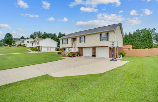 Split Foyer home, brick, vinyl siding, two car garage, concrete driveway, garage doors, landscaping, front yard, back yard fencing, neighboring homes