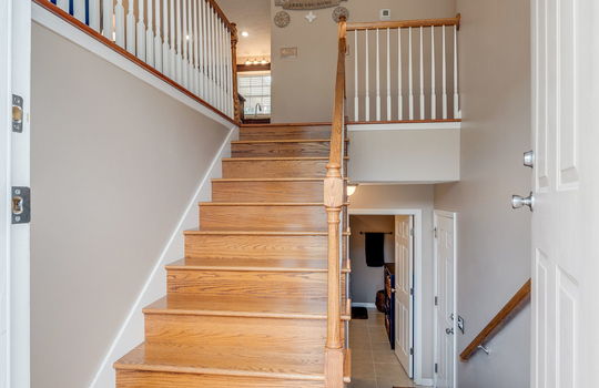 foyer, entryway, stairs to upper level, stairs to lower level