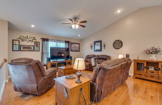 living room, vaulted ceiling, ceiling fan, hardwood flooring, window