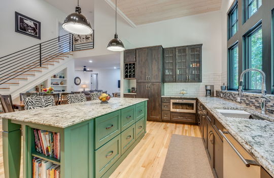 kitchen, custom cabinetry, granite countertops, sink, dishwasher, open concept, living room, kitchen island, stairs to upper level, tile backsplash