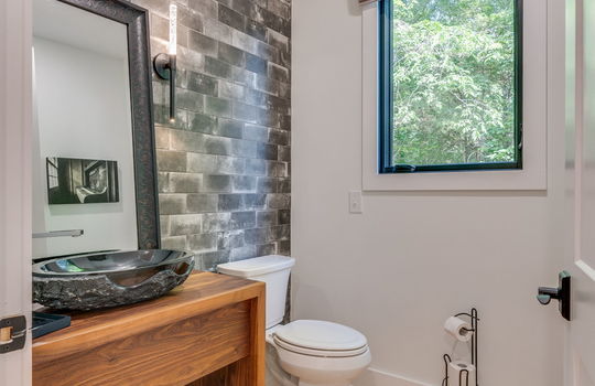 half bath, hardwood flooring, toilet, sink, window