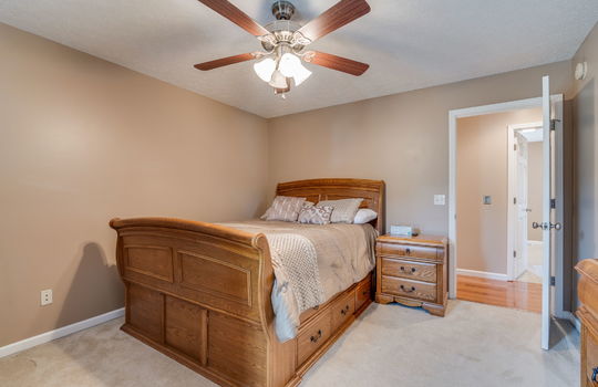 third bedroom, carpet, ceiling fan, door to hallway