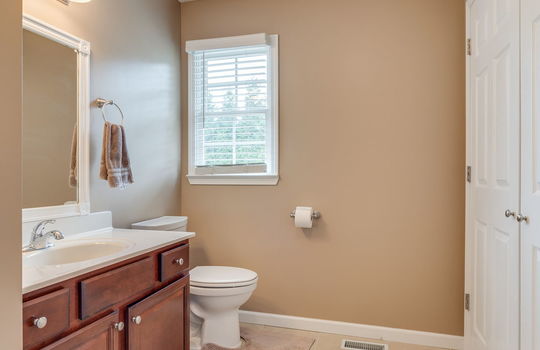 bathroom, storage closet, sink, toilet, window, tile flooring