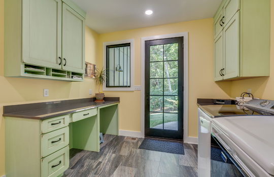 laundry room, washer/dryer hookups, cabinets, tile flooring, exterior door