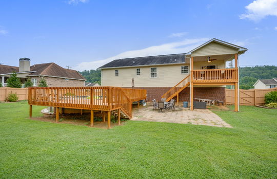 back yard, back deck, pool, pool deck, patio, fully fenced, landscaping, back of home, vinyl siding, brick, covered back deck