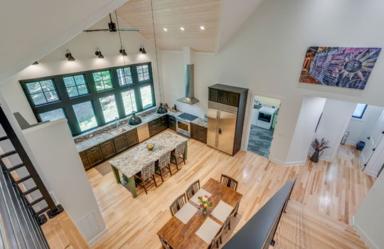 top of stairs overlooking open area above dining room/kitchen, foyer