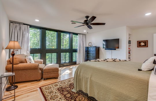 upper level bedroom, hardwood flooring, windows, ceiling fan