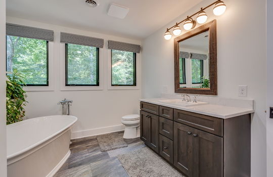 bathroom, tub, vanity, toilet, tile flooring