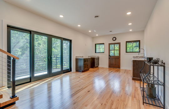 guest home, kitchen, hardwood flooring, lower cabinets, exterior door, windows, double door to back deck, hardwood flooring