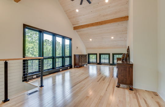 guest home, loft bedroom, ceiling fan, vaulted ceiling, hardwood flooring, windows, recessed lighting