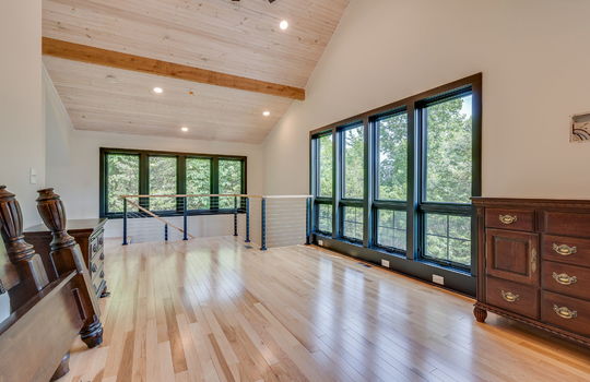 guest home, loft bedroom, vaulted ceiling, windows, recessed lighting, hardwood flooring