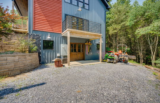 guest home exterior, metal siding, deck, patio, landscaping, gravel driveway