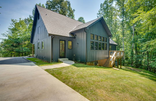 exterior of main home, contemporary home, back deck, stairs, metal siding, side door, concrete driveway