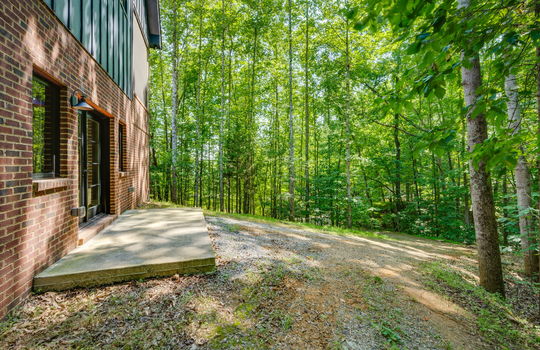 back yard, back patio, back entrance, trees, brick, metal siding