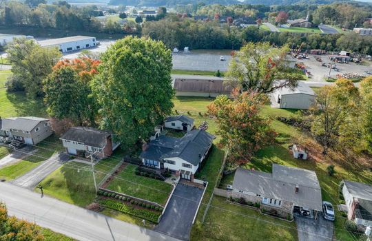 aerial view of property, road, neighboring homes, neighboring businesses, mountains