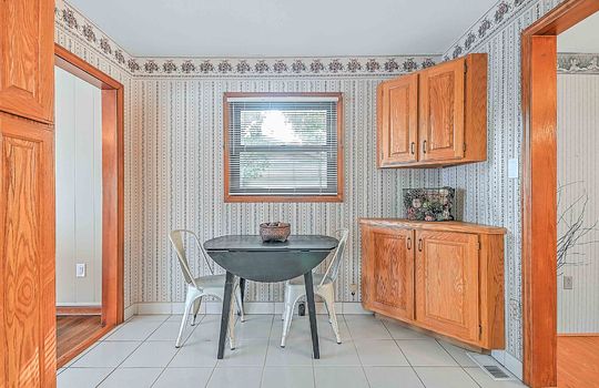 Eat-in Kitchen space, breakfast nook, cabinets, window, tile flooring