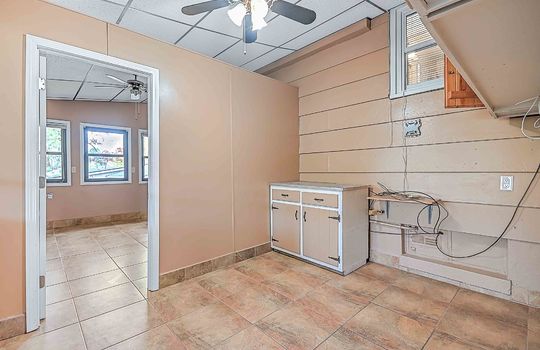 utility room, tile flooring, ceiling fan, window, door