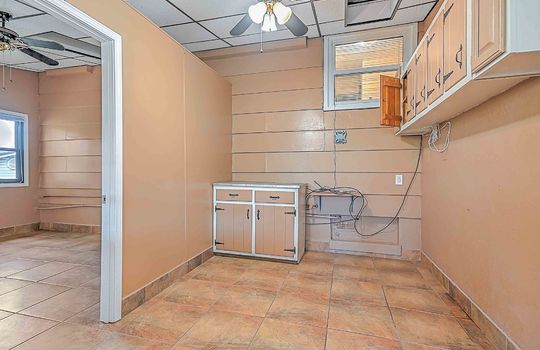 utility room, cabinets, tile flooring, window