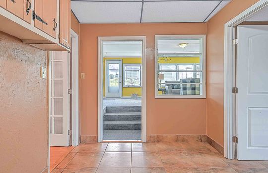hallway, tile flooring, doorway to sunroom, exterior door