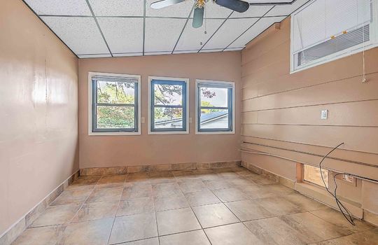 Room, tile flooring, ceiling fan, windows
