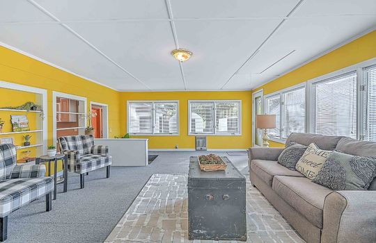 heated sunroom, windows, exterior door, indoor/outdoor carpet, built-in shelving