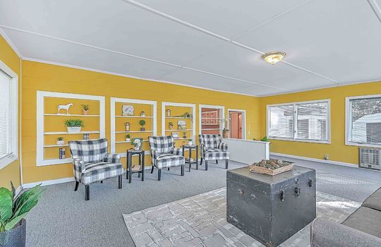 heated sunroom, windows, exterior door, indoor/outdoor carpet, built-in shelving