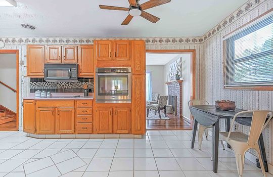 kitchen, tile flooring, eat-in kitchen space, cabinets, wall oven, built-in microwave, cabinets, countertops